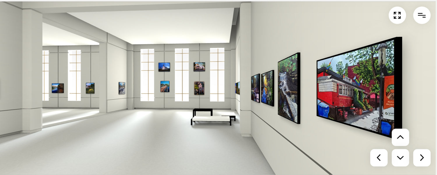 A modern white gallery room with multiple framed art prints displayed on the walls, including a prominent print of a red train scene on the right.