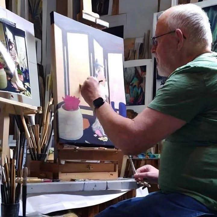 Artist Harold Dumas at the easel painting The Tea Room